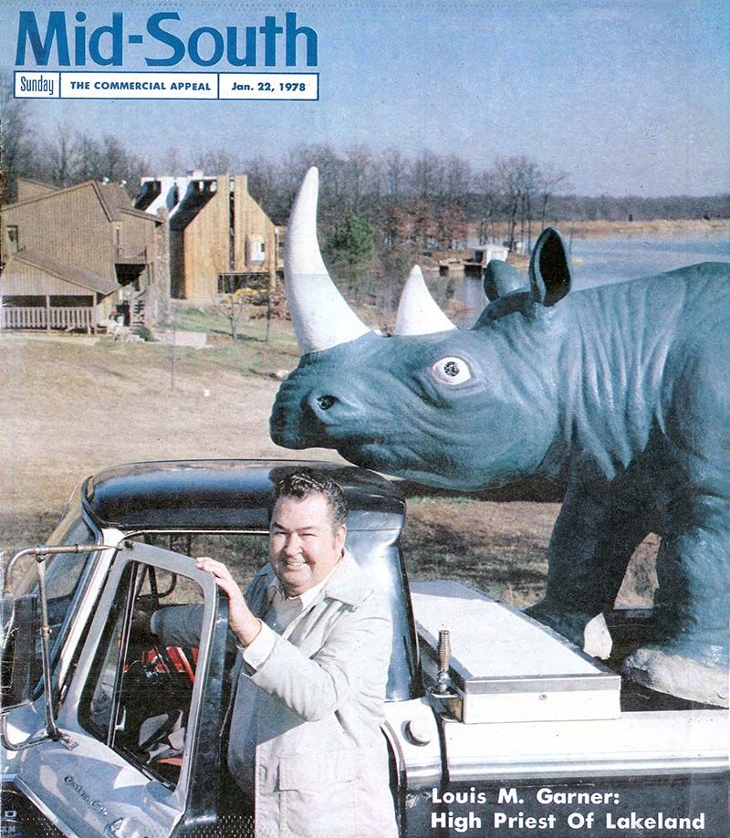 Louis Garner in front of homesites and a fibreglass rhinosaurus