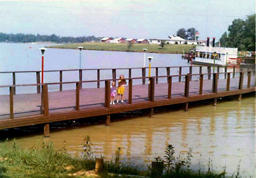 two kids standing on the pedestrian bridge that crossed the lake at Lakeland Amusement Park