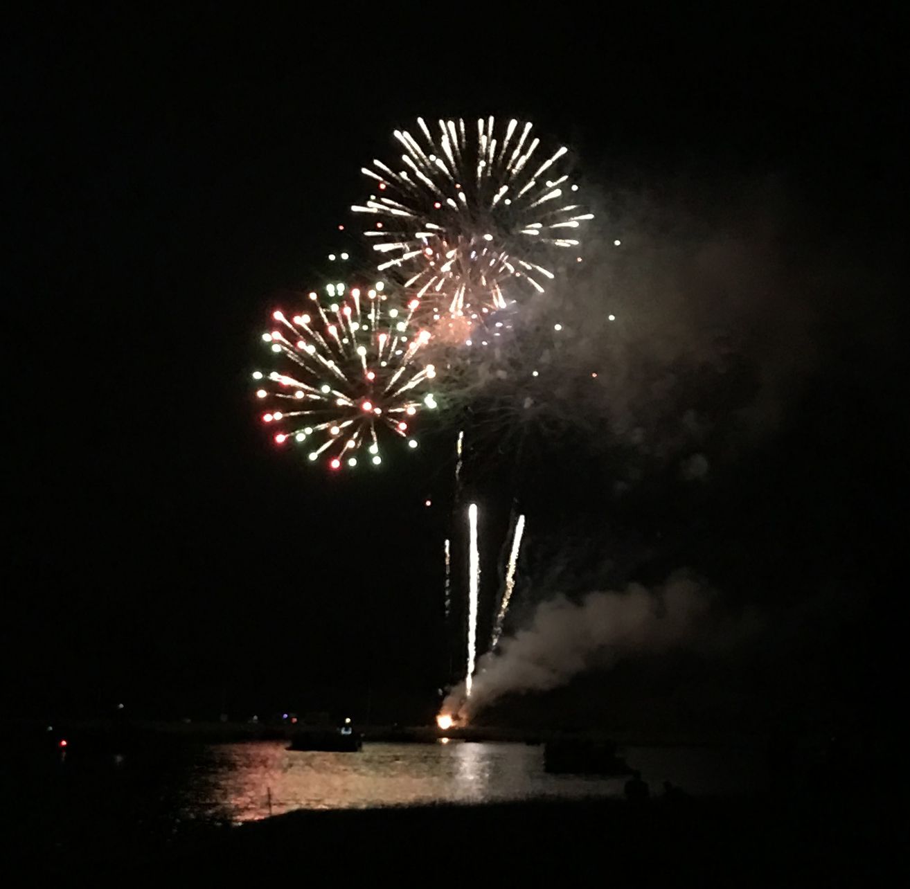 Fireworks over Garner Lake with boats in the foreground