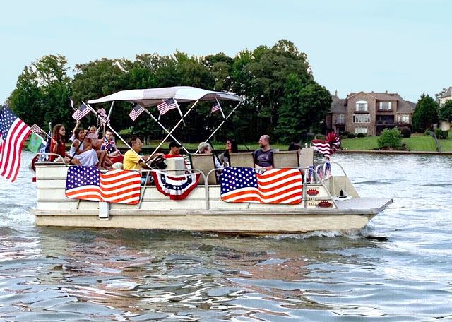 a 1 hrpontoon boat decorated for the Fourth of July